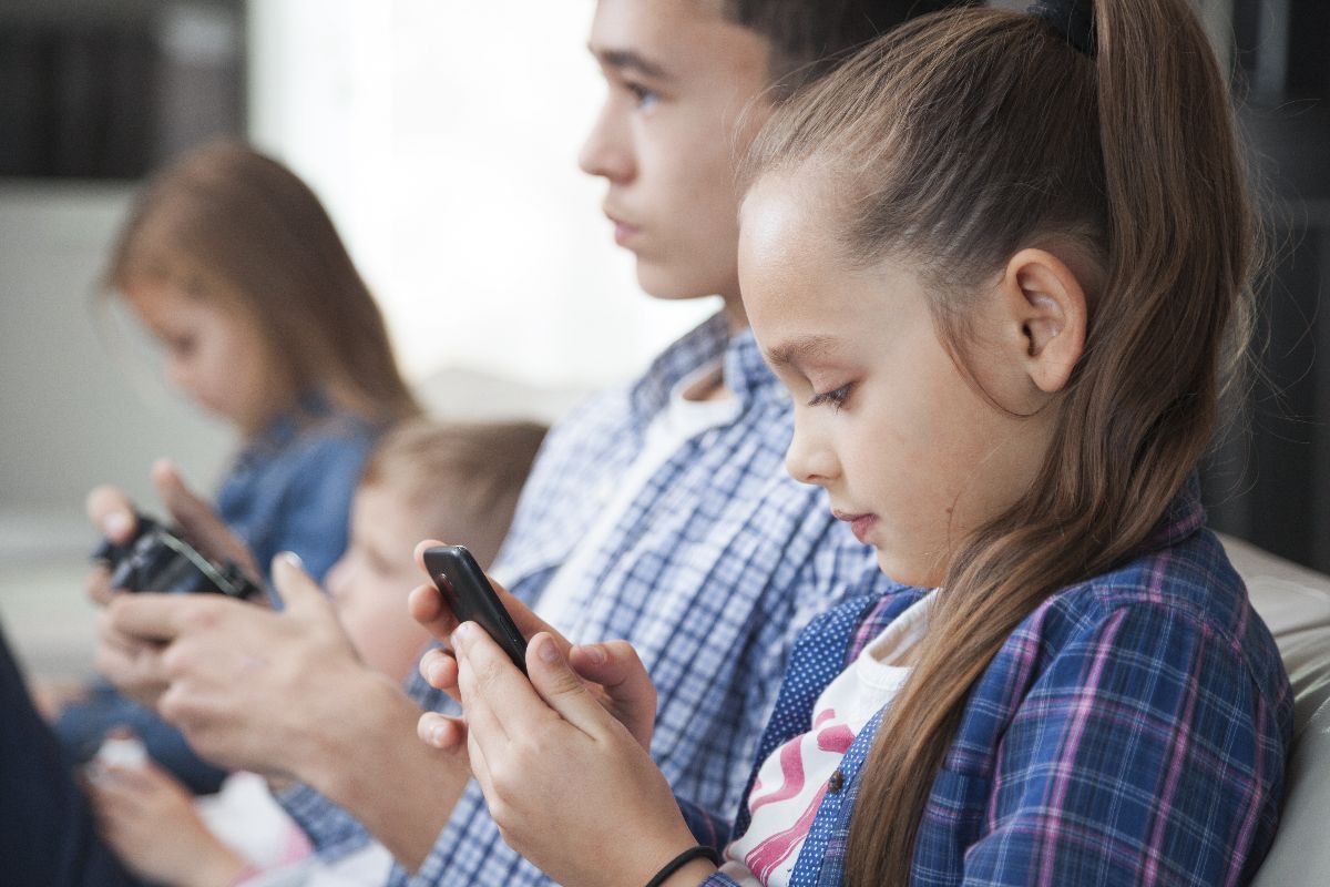Side view siblings with smartphone controller